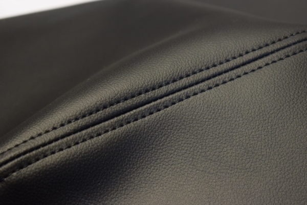 Close-up view of a Racetorations Double Stitched Dashboard Top and Crash Pad Cover Set - TR5-6 with detailed stitching, highlighting the texture and quality of the material.